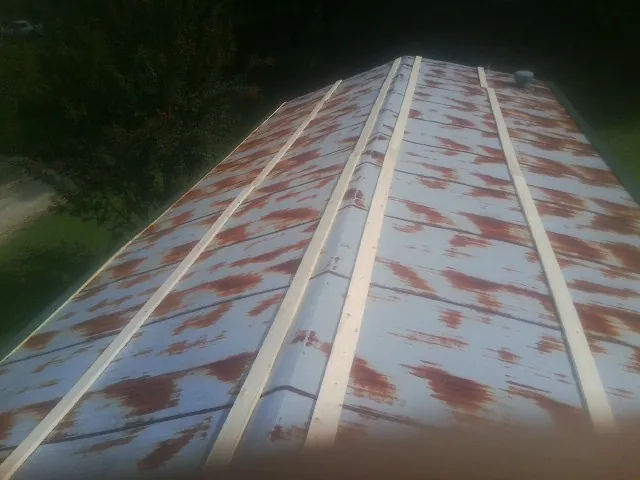 Rusted metal roof panels with new wood purlins before replacement — Storm Damage Roof Repair in Otego by Roofing Brothers